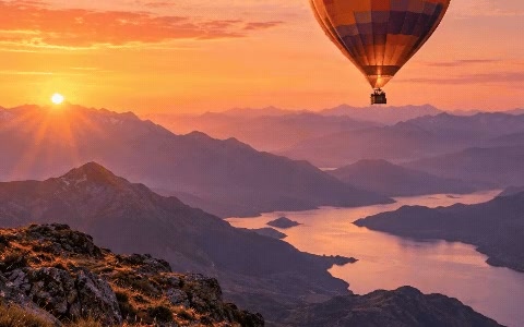 A hot-air balloon over mountains at sunset with parallax motion