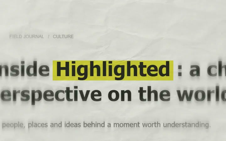 A highlighted keyword held in position across newspaper text